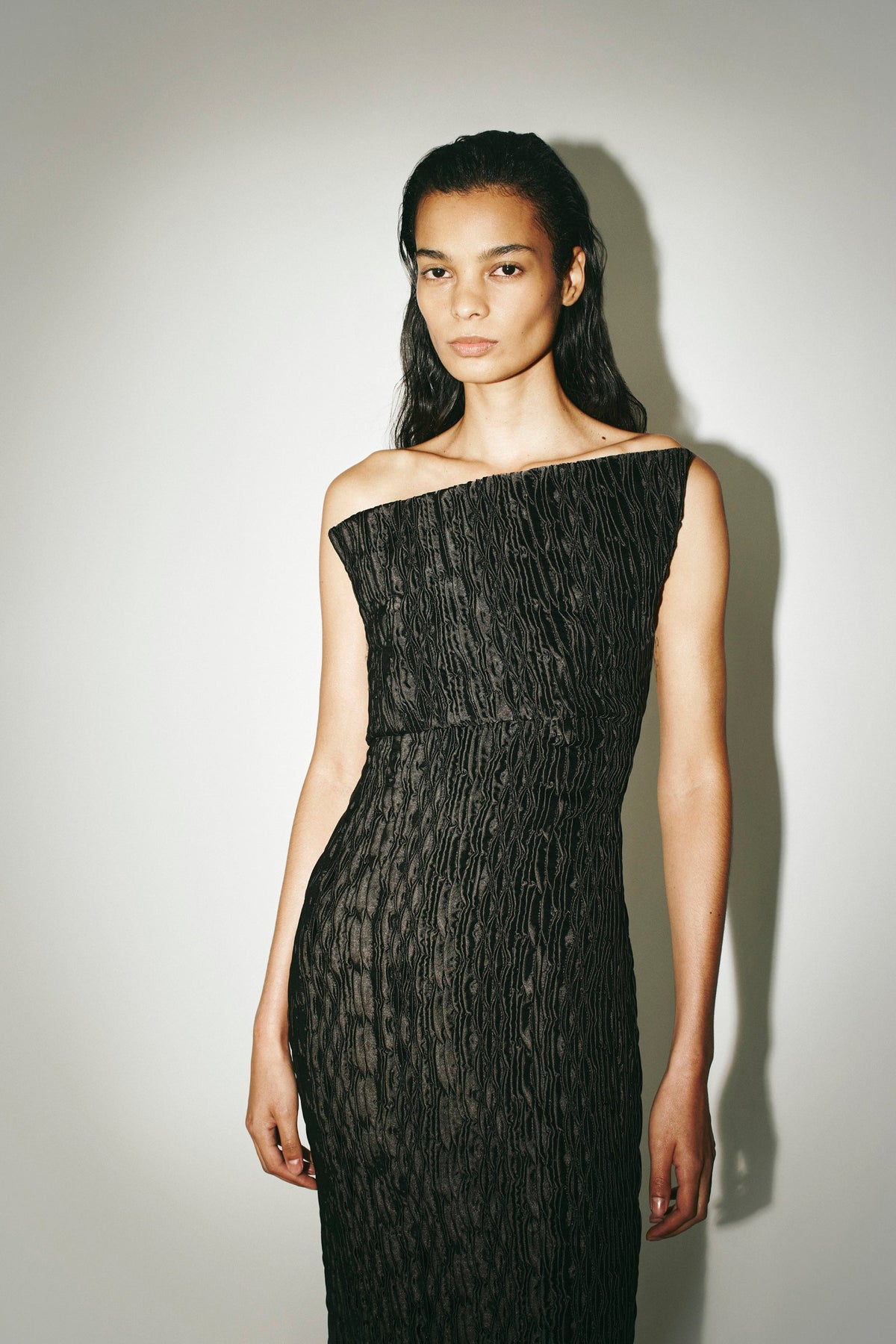 Front Styled View CAMILLA AND MARC Elise Dress in black, strapless asymmetric midi dress with fitted column silhouette.