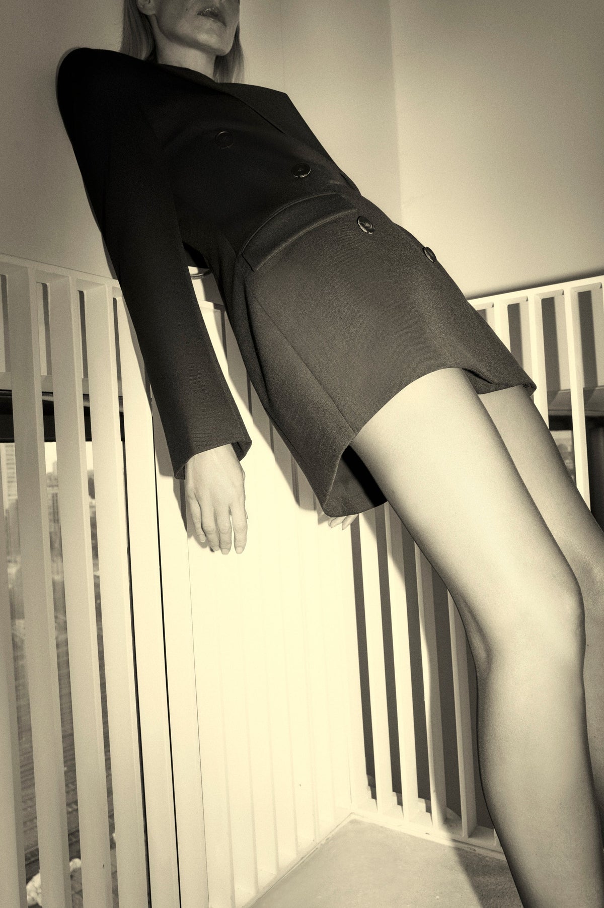 Close up view CAMILLA AND MARC Cassie long sleeve mini dress in black with open back removable chain detail.