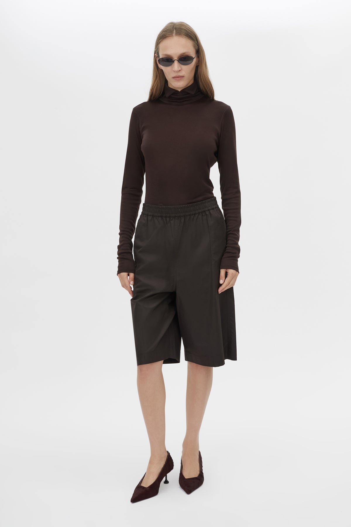 Front view CAMILLA AND MARC Barre High Neck Top in Chocolate with long sleeves and turtleneck silhouette.  