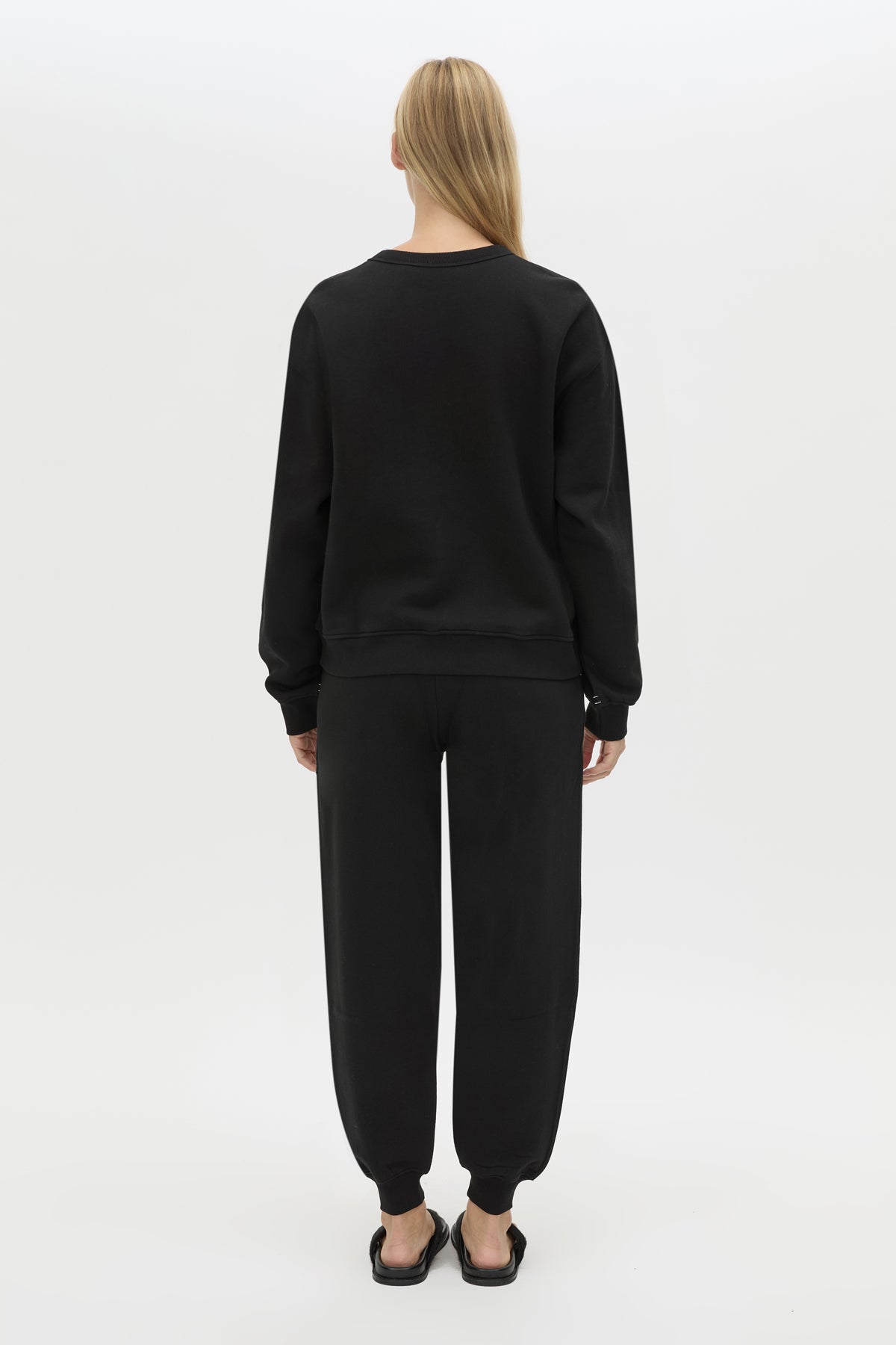 Back view CAMILLA AND MARC Bonnie relaxed logo track pant in black with elasticated drawcord waistband.
