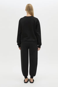 Back view CAMILLA AND MARC Bonnie relaxed logo track pant in black with elasticated drawcord waistband.
