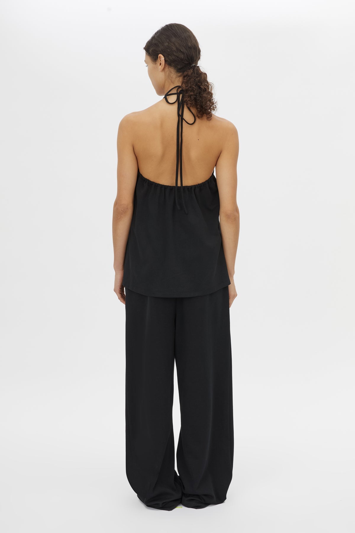 Back view CAMILLA AND MARC Canova Relaxed Pant in Black jersey with gathered waistband and drawcord.