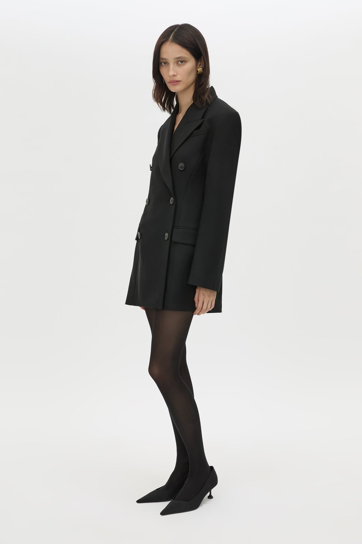 3/4 styled view CAMILLA AND MARC Cassie long sleeve mini dress in black with open back removable chain detail.