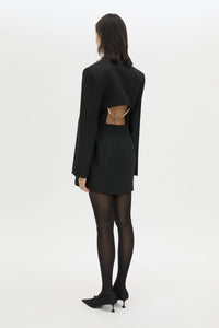 Back styled view CAMILLA AND MARC Cassie long sleeve mini dress in black with open back removable chain detail.