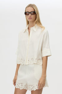 Cropped view CAMILLA AND MARC Chara Embroidered Cropped Shirt in Cream with short sleeves, lace hem and slight A‑line fit.