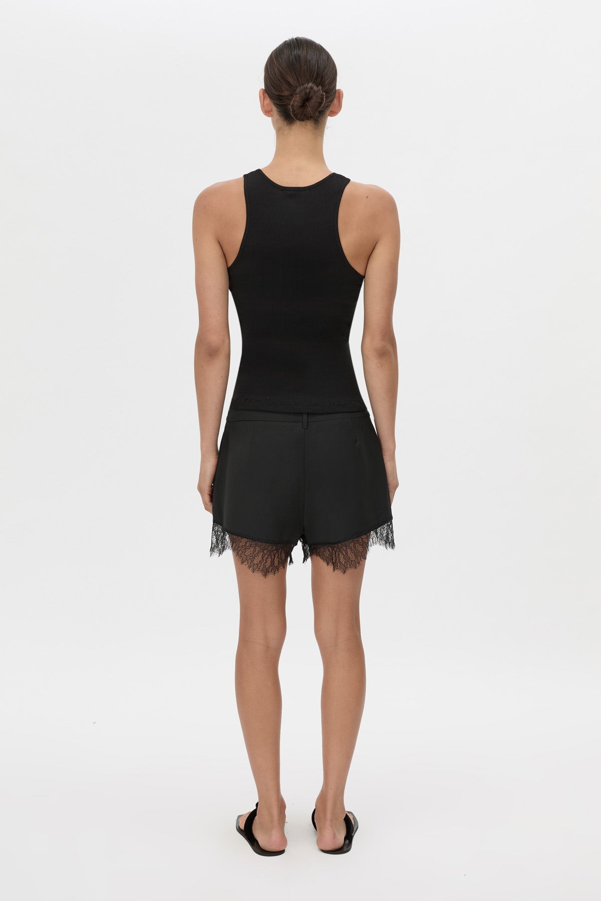 Back view CAMILLA AND MARC Chiaro Mini Short in black with lace hem detail.