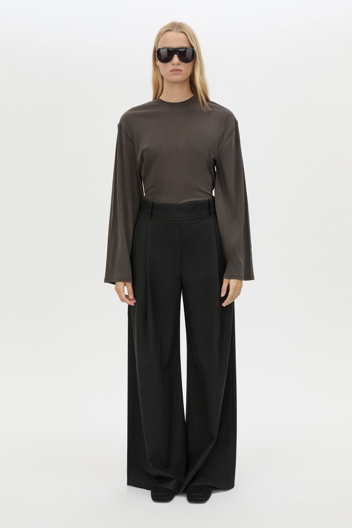 Tucked view CAMILLA AND MARC Dakota long sleeve relaxed top in charcoal grey with crew neckline and semi-sheer fabrication.