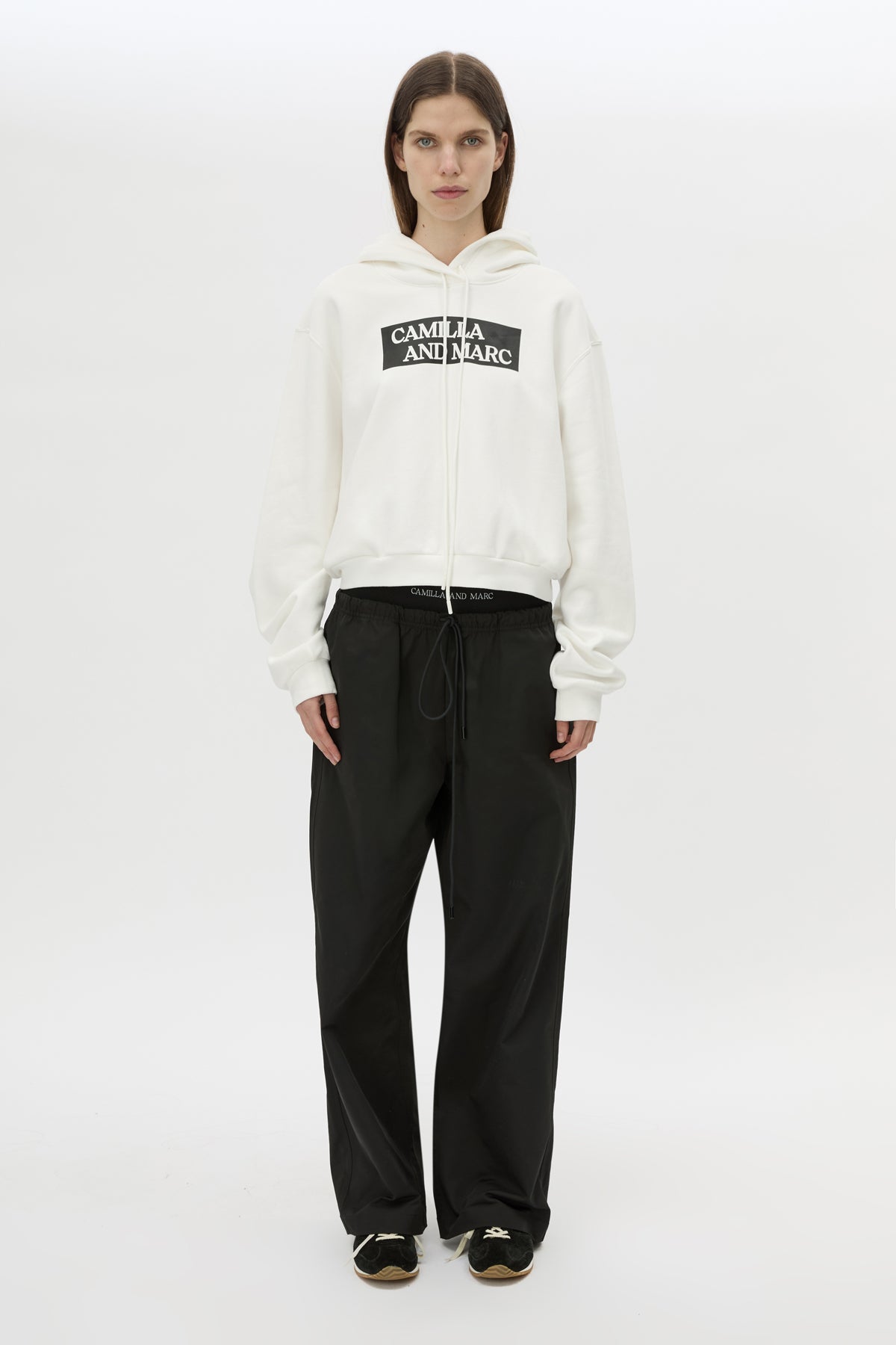 Front styled view CAMILLA AND MARC Dia Elastic Detail Pant in Black with logo detail.