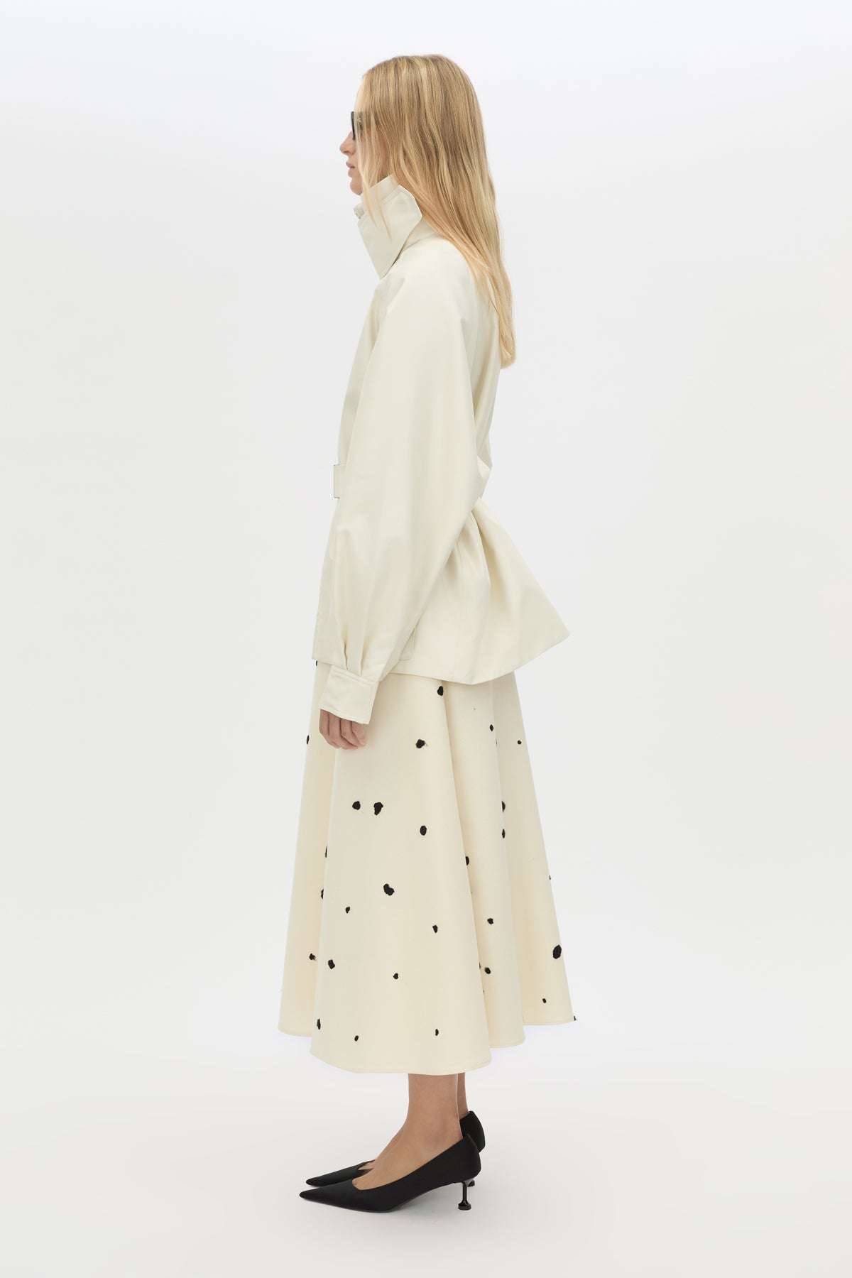 Side view CAMILLA AND MARC Drea funnel neck puffer jacket in cream with utility waistbelt and detachable throat latch.
