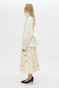 Side view CAMILLA AND MARC Drea funnel neck puffer jacket in cream with utility waistbelt and detachable throat latch.