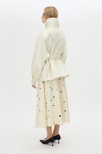 Back view CAMILLA AND MARC Drea funnel neck puffer jacket in cream with utility waistbelt and detachable throat latch.