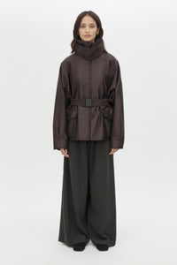 Front styled view CAMILLA AND MARC Drea Puffer Jacket in Espresso Brown with funnel neck and padded puffer silhouette.