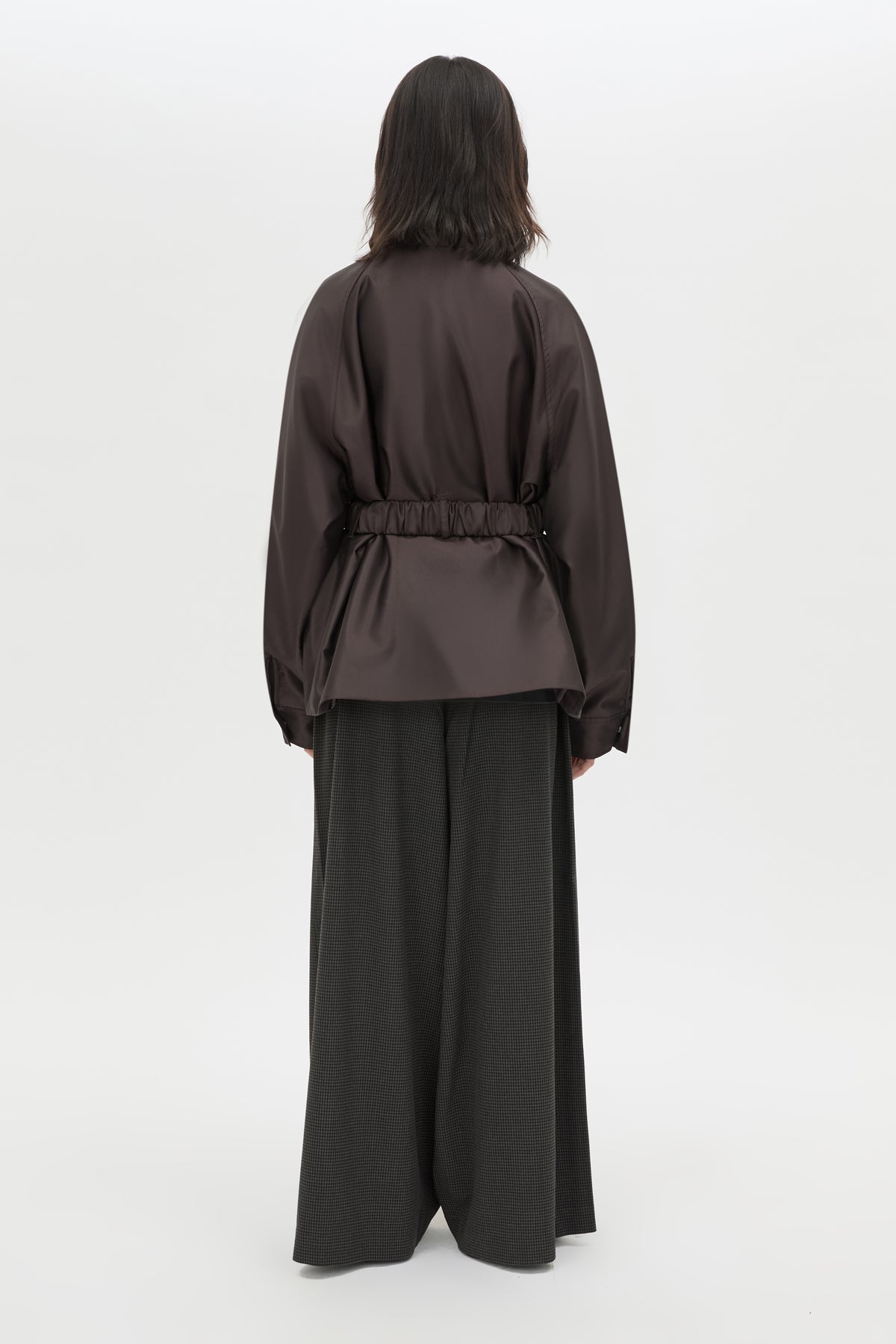 Back view CAMILLA AND MARC Drea Puffer Jacket in Espresso Brown with funnel neck and padded puffer silhouette.