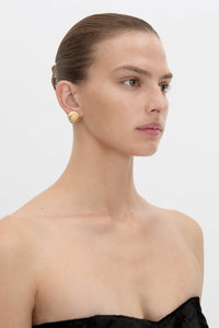 Side view CAMILLA AND MARC Eagan Earrings in gold with round semi‑sphere design and ruched texture.