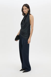 Three-quarter view CAMILLA AND MARC Elowyn Halter Top in French Navy with a draped open back and asymmetric hem.