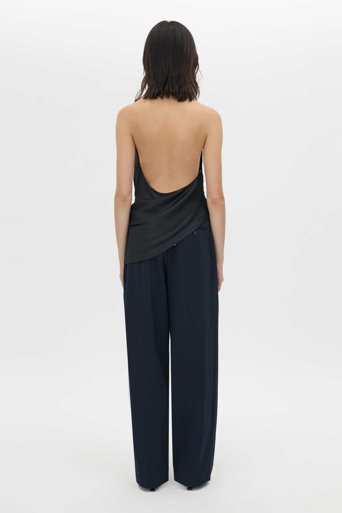 Back view CAMILLA AND MARC Elowyn Halter Top in French Navy with a draped open back and asymmetric hem.