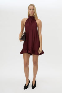 Front styled view CAMILLA AND MARC Elsen Halter Mini Dress in Burgundy with open back, tie‑up neck and fluted crinoline hem.