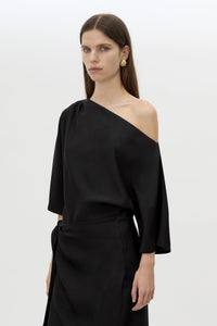 Cropped view CAMILLA AND MARC Elsen Off Shoulder Midi Dress in Black with asymmetric neckline.