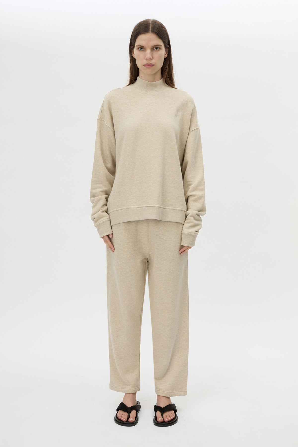 Front styled view CAMILLA AND MARC Lloyd Sweater in Cream with a ribbed turtleneck and an embroidered chest monogram.