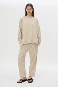 Front view CAMILLA AND MARC Lloyd Sweater in Cream with a ribbed turtleneck and an embroidered chest monogram.