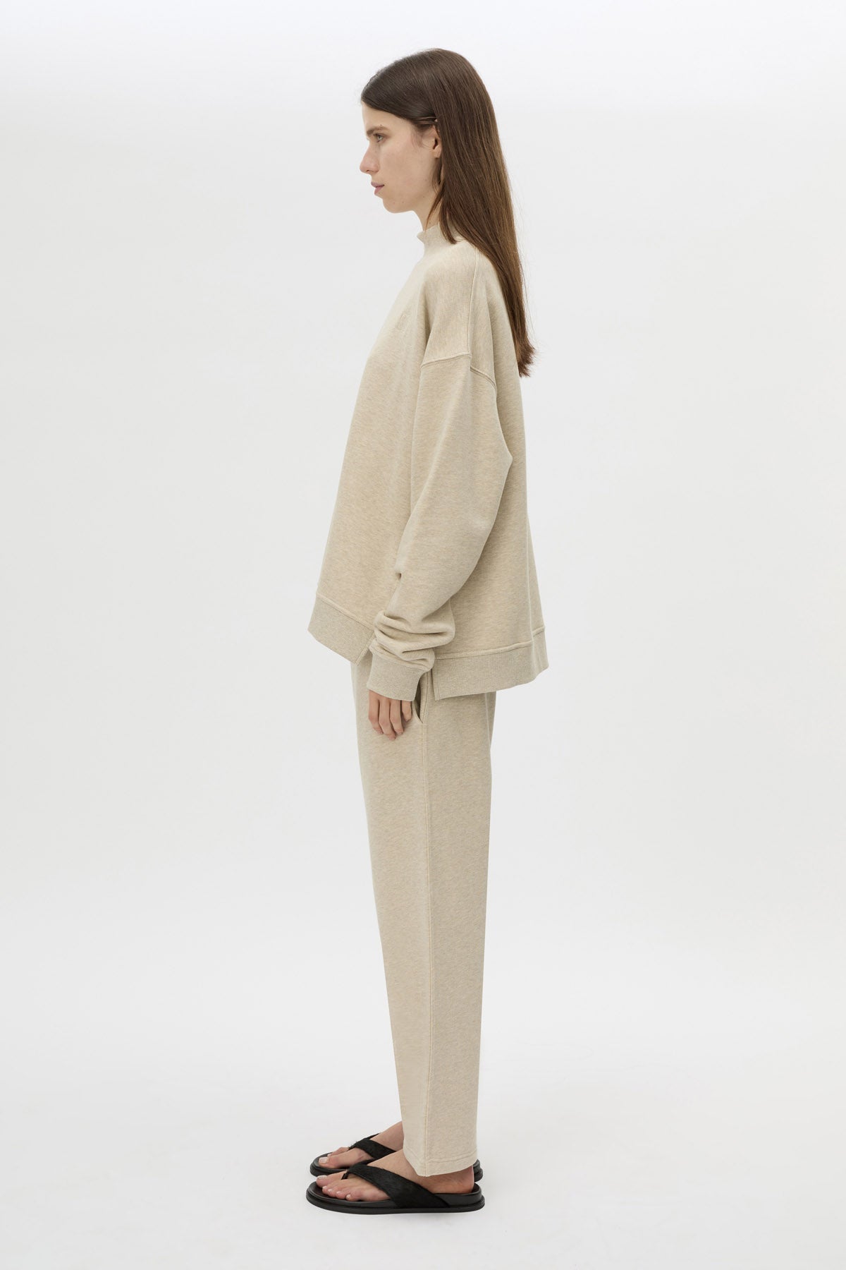 Side view CAMILLA AND MARC Lloyd Sweater in Cream with a ribbed turtleneck and an embroidered chest monogram.