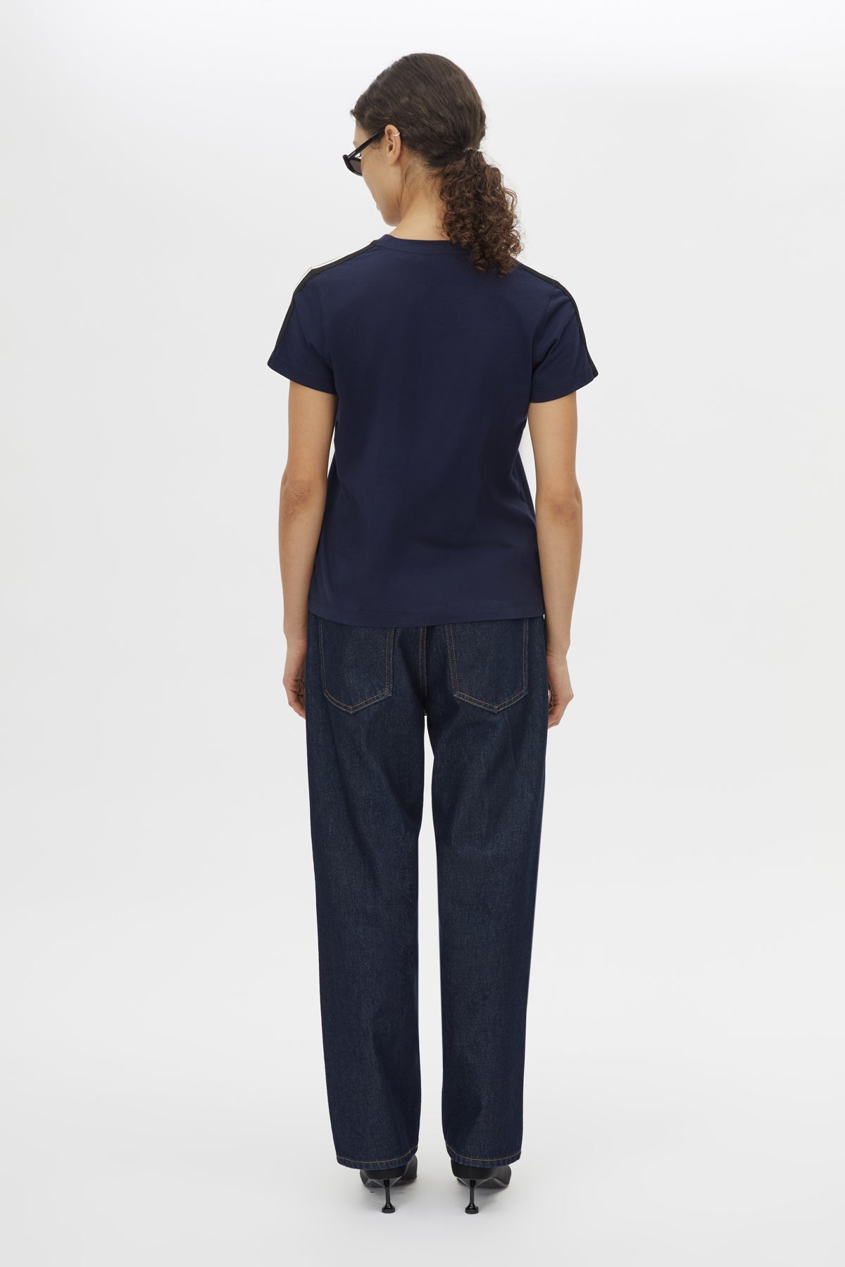 Back view CAMILLA AND MARC Locus Tee in Navy with fitted baby‑tee silhouette and contrast stripe tape.  