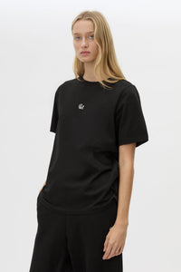 Cropped view CAMILLA AND MARC Lyra Logo Tee in Black with a 100% cotton fabrication.