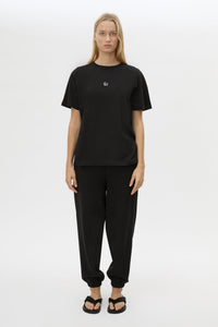 Front view CAMILLA AND MARC Lyra Logo Tee in Black styled with the Lyra Trackpant.