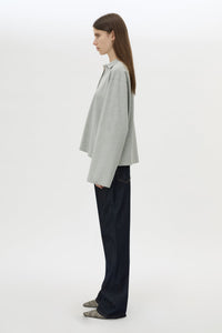 Side view CAMILLA AND MARC Moreno Long Sleeve Polo Top in Grey Marle with quarter button placket, and embroidered monogram.