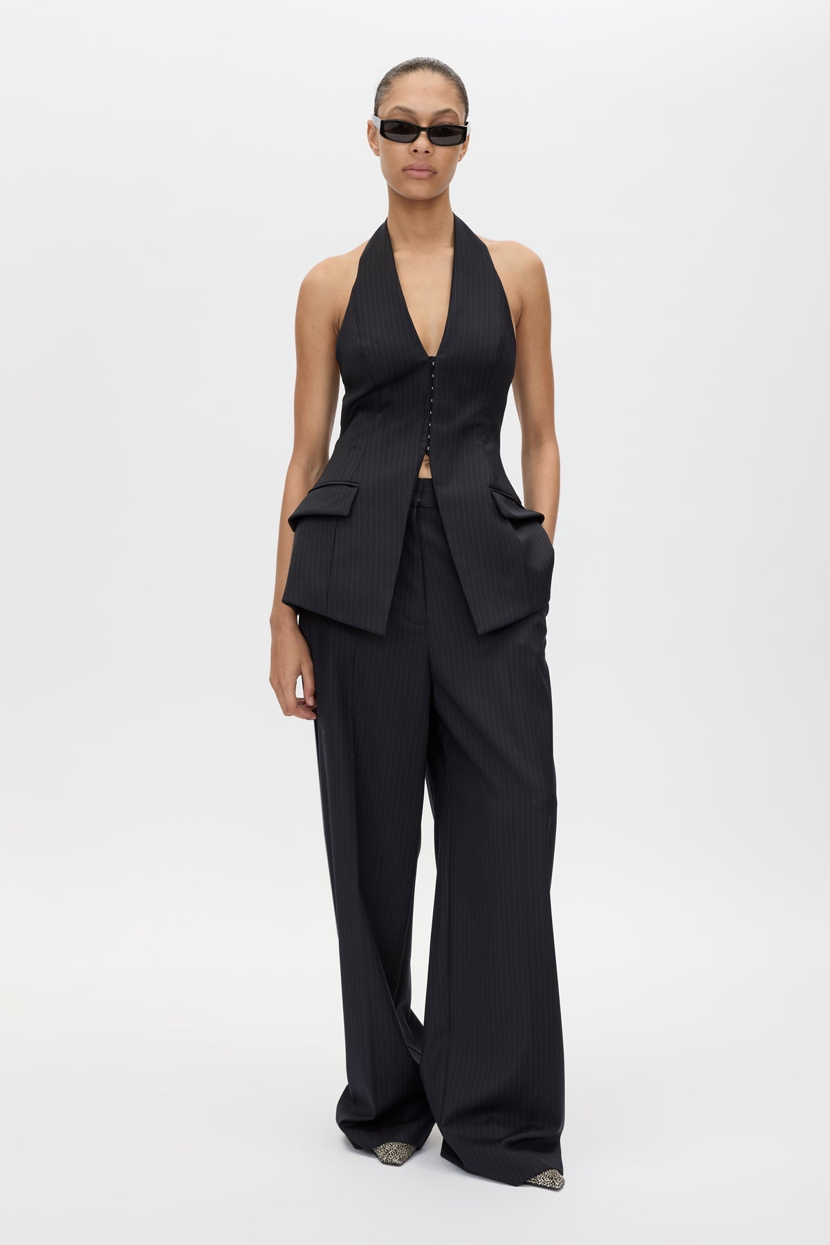 Front styled view CAMILLA AND MARC Orban Tailored Halter Top in Navy Pinstripe with deep V‑neck, fitted waist and open back.
