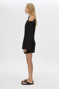 Side view CAMILLA AND MARC Serenitas Mini Dress in Black with off the shoulder long-sleeves.