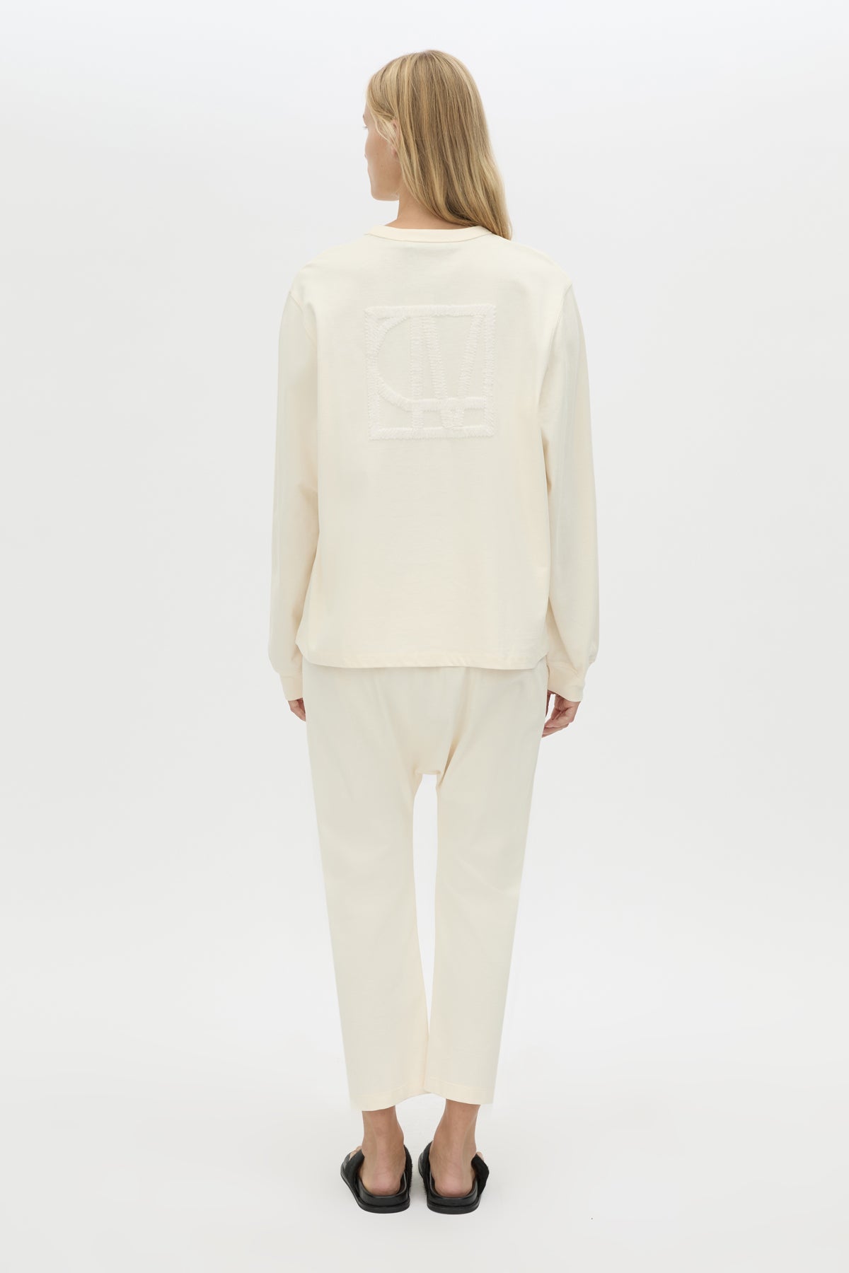 Back view CAMILLA AND MARC Studio cropped mid-rise track pant in winter white with elasticated waistband. 