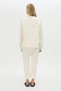Back view CAMILLA AND MARC Studio cropped mid-rise track pant in winter white with elasticated waistband. 
