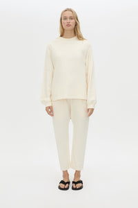Front styled view CAMILLA AND MARC Studio cropped mid-rise track pant in winter white with elasticated waistband. 
