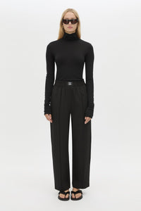 Styled view CAMILLA AND MARC Sylvia soft suiting high-waisted pant in black with monogram patch at waistband.