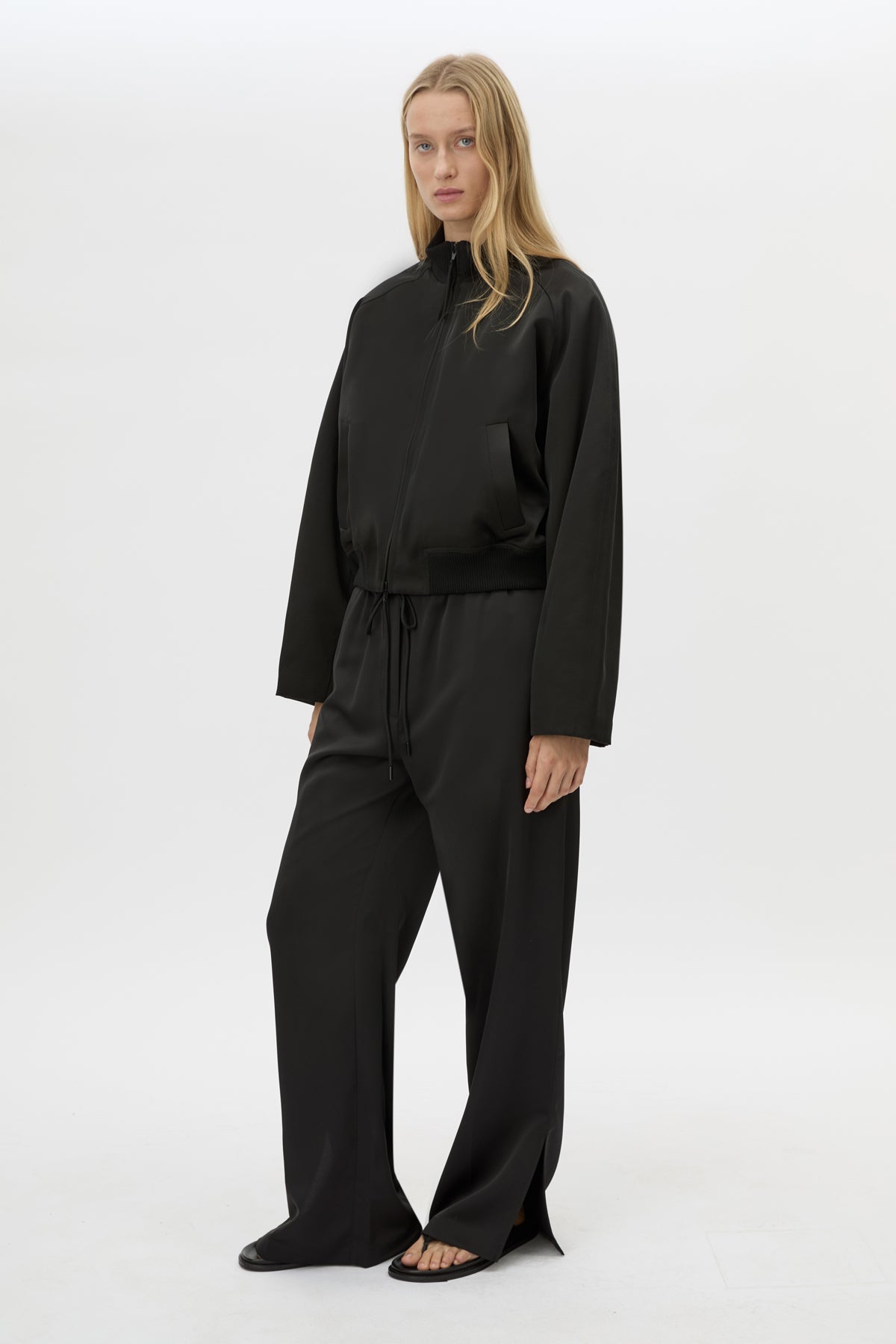 Front view CAMILLA AND MARC Tamar Satin Bomber Jacket in Black styled with the Ground Satin Pant.