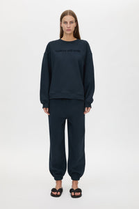 Front styled view CAMILLA AND MARC Tia Flocking Logo Crew in Deep Ink with relaxed fit, logo artwork and 100% cotton.