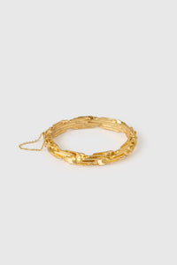 Side view CAMILLA AND MARC Wrenley Bangle with worn‑look 18k gold plating featuring an interlocking chain design.