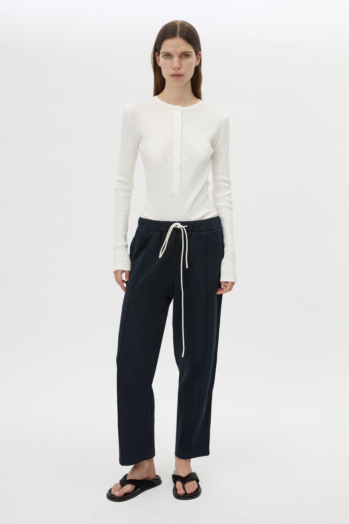 Styled view CAMILLA AND MARC Zylus straight-leg tracksuit pant in navy with embroidered monogram.