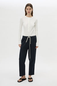 Styled view CAMILLA AND MARC Zylus straight-leg tracksuit pant in navy with embroidered monogram.