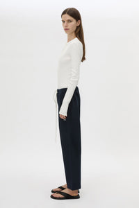 Side view CAMILLA AND MARC Zylus straight-leg tracksuit pant in navy with embroidered monogram.